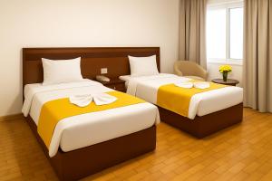 Postel nebo postele na pokoji v ubytování Miramar Evergreen Hotel