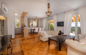 a living room with a couch and a table at Cozy Apartment In Banjol With Wifi in Banjol