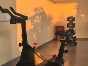 a gym with an exercise bike in a room at Zhangjiajie The Brookside Hotel& Tianmen National Forest Park & Free pick up service in Zhangjiajie