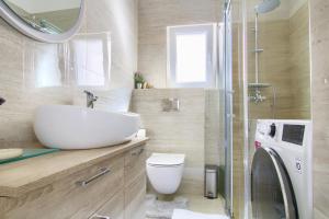 a bathroom with a sink and a toilet and a shower at Stella Maris in Kali +56 photos