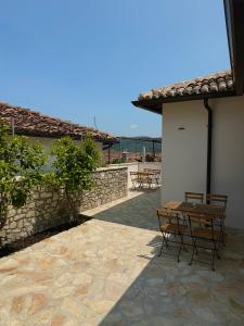 a patio with tables and chairs on a building at Villa Merkaj, Berat Castle in Berat
