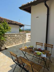 a wooden table and chairs on a patio at Villa Merkaj, Berat Castle in Berat