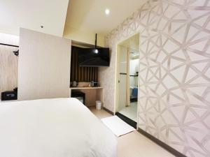 Sjónvarps- og/eða afþreyingartæki á 新仕飯店-New City Hotel