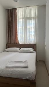 a bedroom with a large bed with a window at Aqua Batumi 47 in Batumi +11 photos