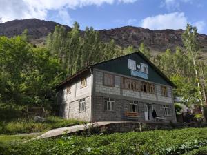 an old house in the middle of a field at Jumaboy Guesthouse - Transport, Rooms & Hiking Tours in Nofin