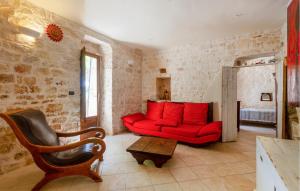 a living room with a red couch and a chair at 3 Bedroom Cozy Home In Ostuni in Ostuni
