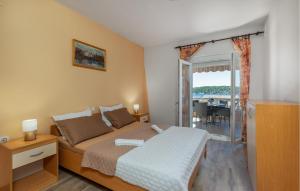 a small bedroom with a bed and a balcony at Lovely Apartment In Barbat Na Rabu in Barbat na Rabu