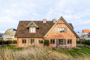 a brick house with a black roof at Haus Hyggelig in List