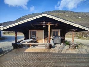 a log cabin with a stove in front of it at Cabin Pikku Saana in Kilpisjärvi