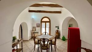 a dining room with a table and a red refrigerator at Dimora Life in Locorotondo