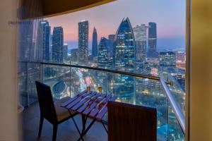 a restaurant with a view of a city skyline at Creston Suites The Dubai Mall Residences in Dubai