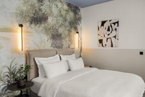 Ένα ή περισσότερα κρεβάτια σε δωμάτιο στο Airio Athens Suites