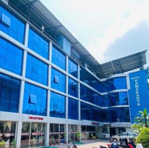 an office building with blue windows and motorcycles parked outside at Hotel Kamakshya Pvt Ltd in Kodudanga