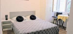 a bedroom with a bed with two pillows on it at Studio Apt, Promajna, Makarska Rivijera in Promajna