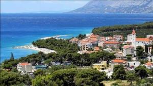 a town on a hill next to the ocean at Studio Apt, Promajna, Makarska Rivijera in Promajna
