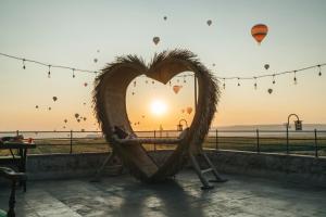 a heart shaped bench with the sunset in the background at İncebey Konak Cappadocia in Uchisar