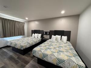 a hotel room with two beds and a window at Studio 6 Tacoma, WA - South in Tacoma