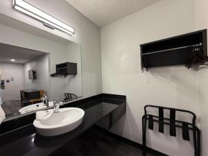 a bathroom with a white sink and a mirror at Studio 6 Tacoma, WA - South in Tacoma +16 photos