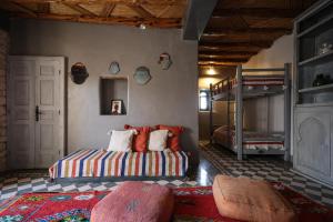 a bedroom with a bed and two bunk beds at Villa Des Arganiers in Essaouira
