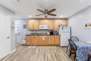 een keuken met houten kasten en een witte koelkast bij 5600 Seaview Ave, Unit 4 in Wildwood Crest