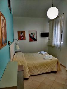 a bedroom with a bed and two pictures on the wall at Affittacamere Ristorante Lo Scudo in Vasto