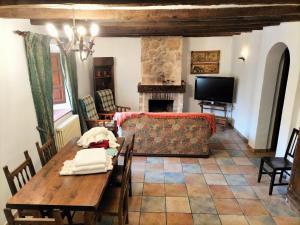 a living room with a table and a couch at Don Camino Casa Aurea in Villalcázar de Sirga