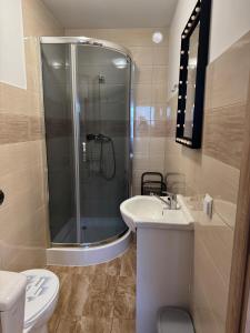 a bathroom with a shower and a sink and a toilet at Domki u Piotrusia in Żarnowska +25 photos