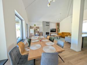 a dining room with a table and chairs at Yellow House in Comarnic