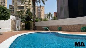 a swimming pool in the middle of a building at Maysan Apartamento in Benidorm