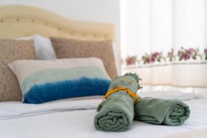 a stuffed animal is laying on a bed at Çağlar my hause apart otel in Turgutreis