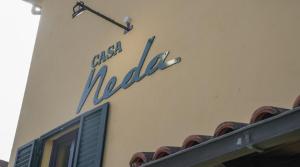 a sign on the side of a building at CASA NEDA Affitacamere in Case Pieve al Toppo +12 photos