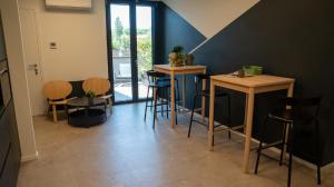 a bar with stools and tables in a room at CASA NEDA Affitacamere in Case Pieve al Toppo