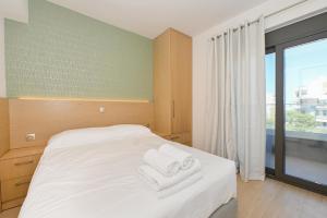 Ένα ή περισσότερα κρεβάτια σε δωμάτιο στο Aelion Eco Apartments