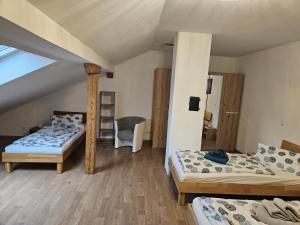 a room with three beds in a attic at Ferienwohnungen März in Söchtenau