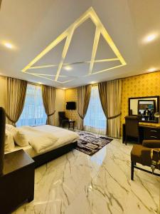 a bedroom with a large bed and a desk at Riviera Resort in Naran +38 photos