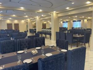 a dining room with tables and chairs and tablesktop at Riviera Resort in Naran