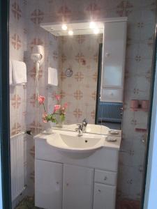 a bathroom with a sink and a mirror at Haus Öfenbichl Ferienwohnungen in Ramsau +32 photos