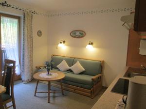 a living room with a couch and a table at Haus Öfenbichl Ferienwohnungen in Ramsau