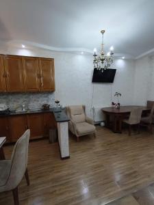 a kitchen and living room with a table and a dining room at A cozy corner in Saburtalo in Tbilisi City