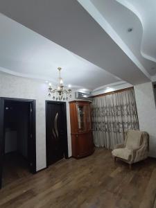 a living room with a couch and a chandelier at A cozy corner in Saburtalo in Tbilisi City