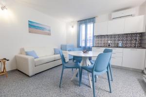 a kitchen and a living room with a table and chairs at Zeus Atabyrios 3 - Open Space in Agrigento +28 photos