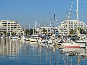 a group of boats docked in a marina with buildings at Luxueux P3 au Grau-du-Roi avec Terrasse et Parking Privé - FR-1-307-73 in Le Grau-du-Roi
