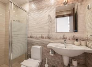 a bathroom with a sink and a toilet and a mirror at Guest House Fotini 2 in Sozopol +92 photos