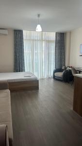 a living room with a bed and a couch at Aqua Batumi 44 in Batumi