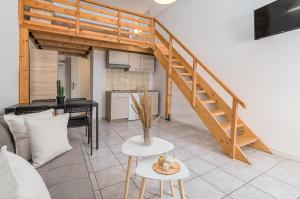 una sala de estar con una escalera en un loft en Zendaya studios, en Polychrono