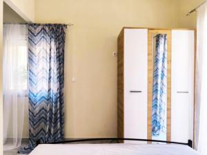 a bedroom with a bed and two dressers at Sokrates Apartments in Preveza +2 photos