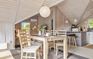 a kitchen and dining room with a wooden table and chairs at Awesome Home In Hejls With Wifi in Hejls