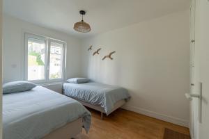 Voodi või voodid majutusasutuse Appartement face Nausicaa , balcon vue mer toas
