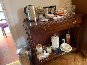 a table with a coffee maker on top of it at Sleepy Hollow Apartment in Cushendun +9 photos