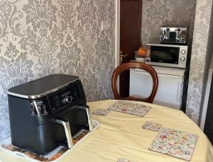 a microwave sitting on top of a table at Sleepy Hollow Apartment in Cushendun +8 photos